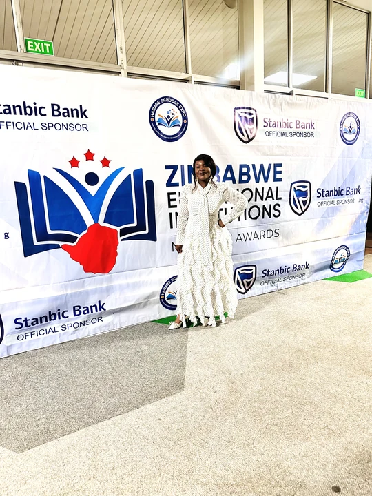A photograph beside the event backdrop.